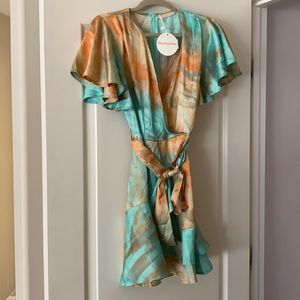 Tie dye flirty dress with ruffle sleeves and bottom.